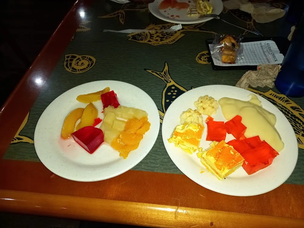 Assorted Fruits with Jello Pudding Coconut Macaroons and a Small Orange Cake